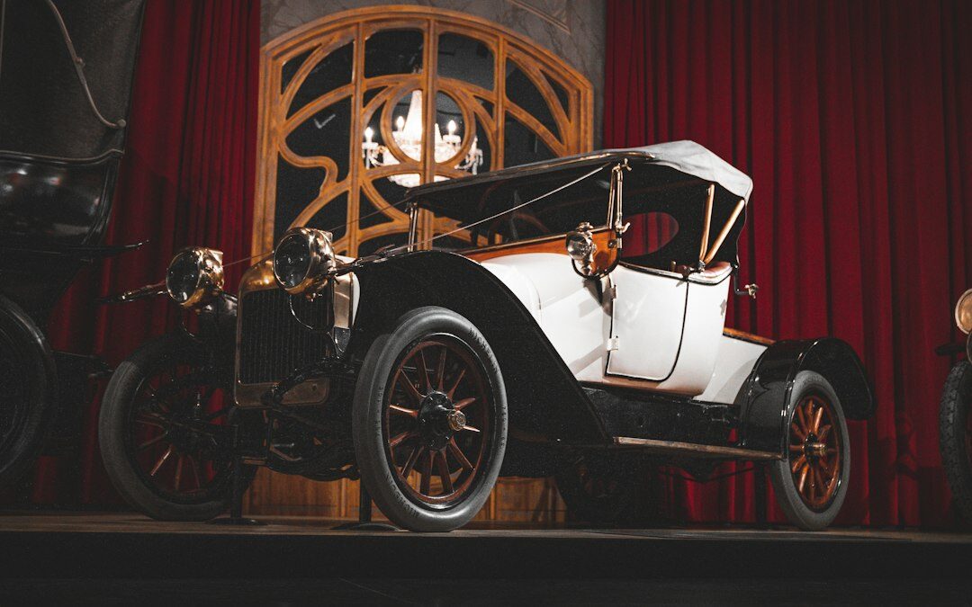 Elegant automobile auction hall with a spotlighted classic car on a rotating stage