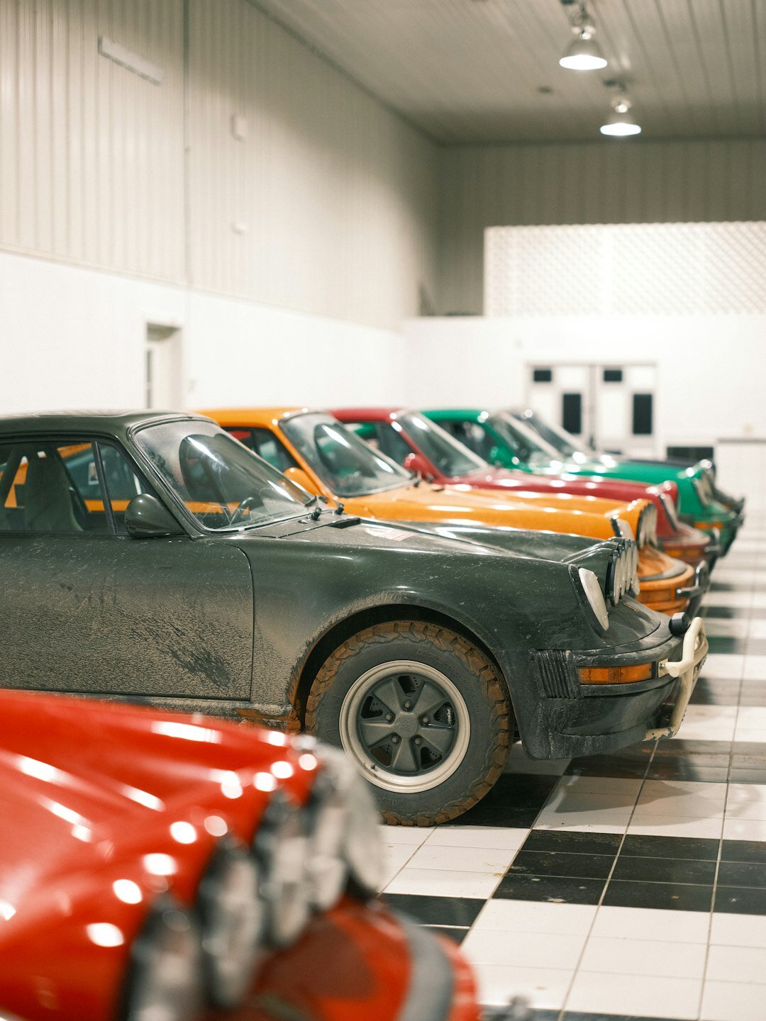 Interior of a classic car museum with rows of restored vintage automobiles