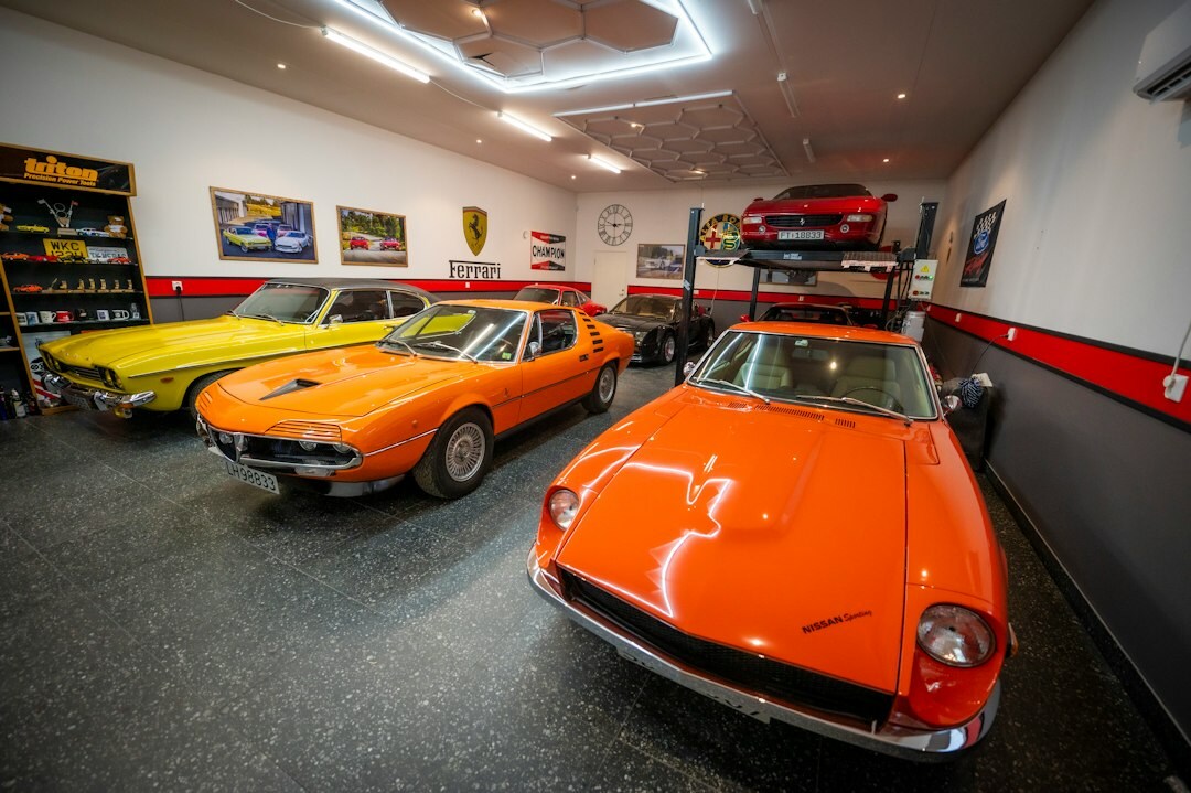 A private garage collection of classic automobiles under warm lighting