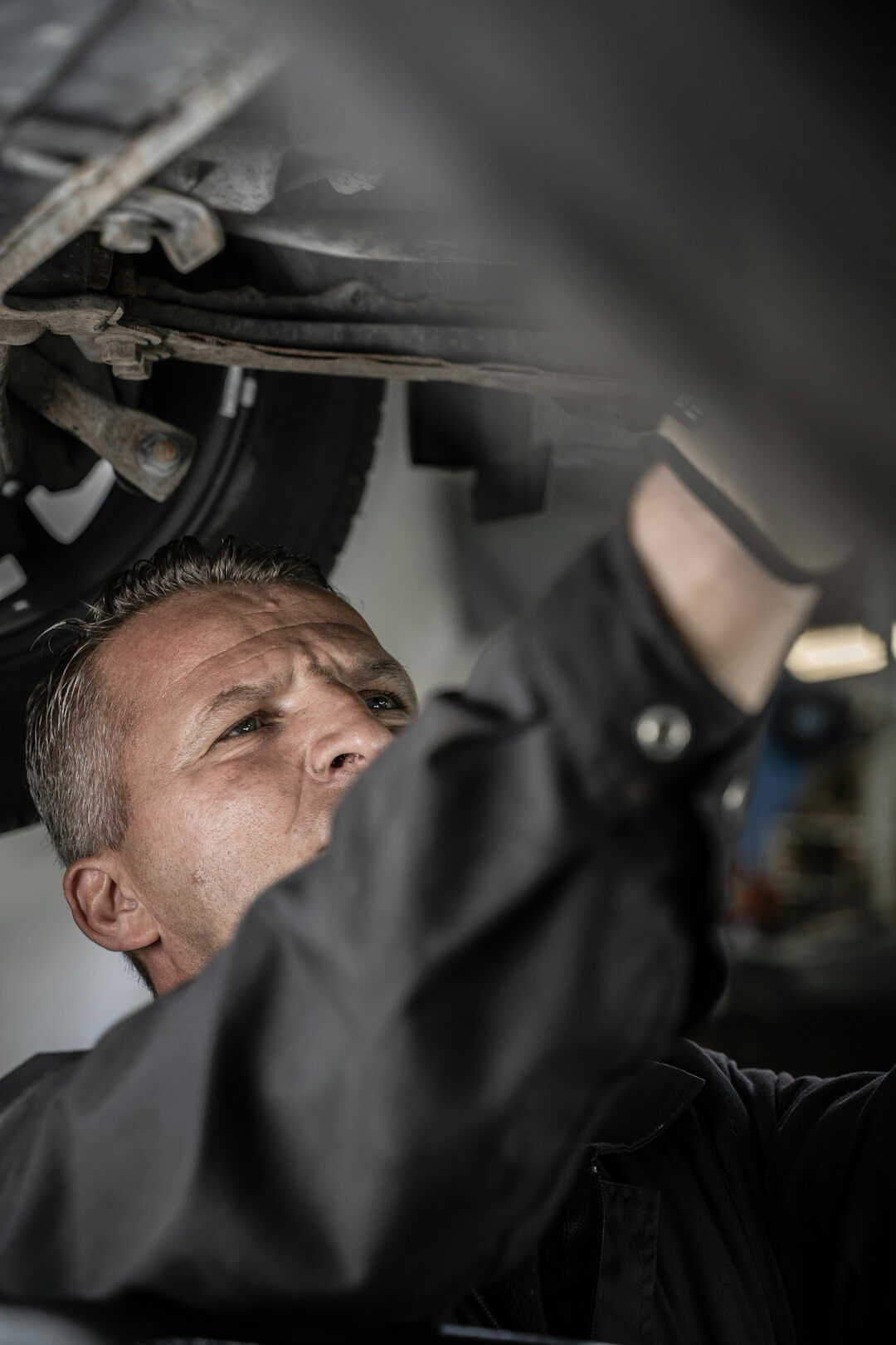 mechanic checking car oil